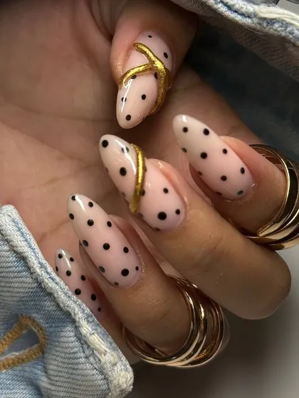 Another view of the stylish polka dot and gold accent manicure, showcasing the creativity and precision of our nail artists.