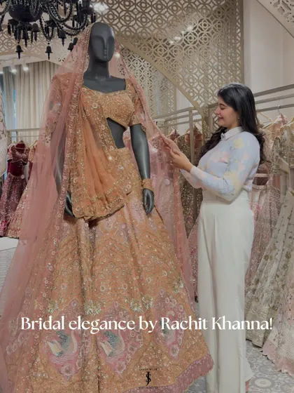 Exploring the world of Rachit Khanna's bridal couture. Here I am admiring a stunning peach lehenga on a mannequin, a perfect example of his bridal elegance.