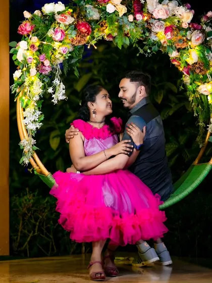 A sweet moment on a circular swing decorated with flowers and lights. I have access to many unique props and setups to make your shoot special.