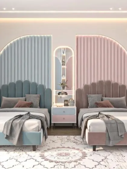A playful yet elegant shared room featuring scalloped headboards in blue and pink. The design is perfectly symmetrical, with a shared central nightstand, creating a balanced and visually pleasing space for siblings.