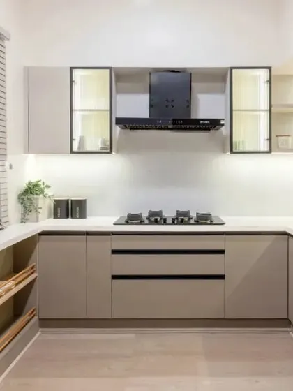 A full view of the U-shaped beige and white kitchen, demonstrating how every inch of space is cleverly utilized for a highly efficient workflow.