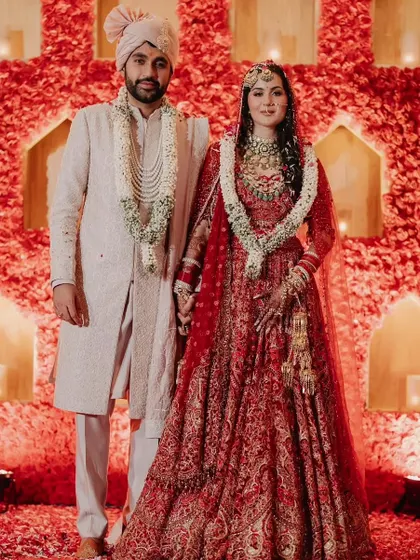 A classic red and ivory theme brought to life with a stunning wall of red roses as the mandap backdrop. This design combines traditional wedding colors with a modern, impactful floral statement for a timeless look.