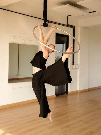 Using the hoop to frame a flexible pose. The circular shape of the lyra provides a perfect canvas for creating interesting and artistic shapes with the body.