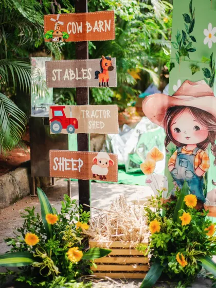 Charming, rustic directional signs pointing to the "Cow Barn," "Stables," and "Tractor Shed." These details help build an immersive and authentic farm experience.