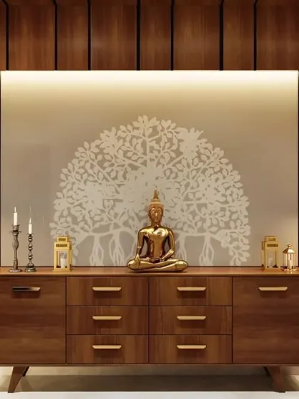 This wide wooden console provides a serene and balanced entryway. A Buddha statue is centered against a wall decal of the Bodhi tree, flanked by elegant floor lamps for a calming atmosphere.