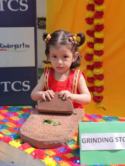 This little star is trying her hand at a traditional grinding stone. Our Baisakhi celebration was full of such hands-on activities that teach children about our heritage.