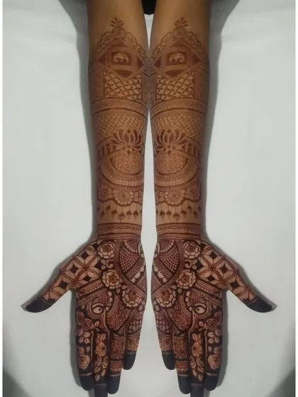 The complete view of a bridal design, showing the symmetry and the flow of patterns from the palm to the mid-arm.