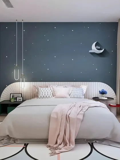 A whimsical bedroom with a starry night-themed accent wall. The design includes a unique curved headboard, a flower-shaped rug, and soft, dreamy lighting, perfect for a peaceful night's sleep.