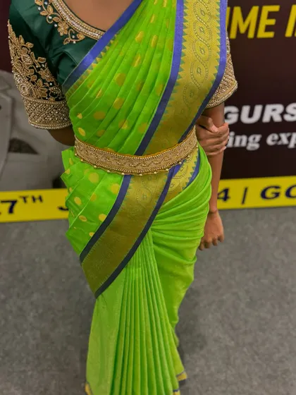 A close-up of the green saree, showing the perfect tuck and the way the pleats fan out beautifully.