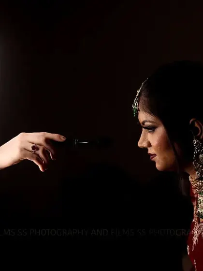 An innovative bridal portrait using a ring light as a prop within the photo. This creative technique frames the bride's face and adds a modern, graphic element to the shot.