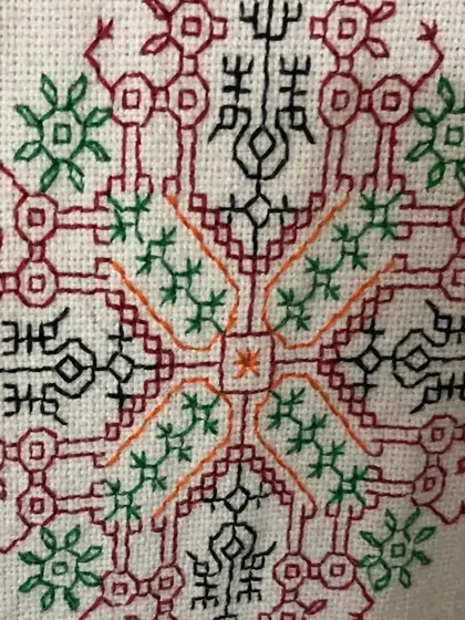 A detailed look at a complex, symmetrical Kasuti motif. Creating such a balanced and intricate design with counted stitches requires a high level of skill and precision.