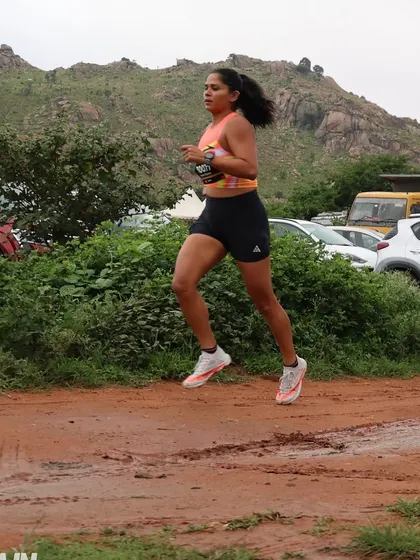 Navigating a muddy patch during a trail race. Trail running requires adaptability and strength to handle varied terrain. My training programs build the stability and power you need to confidently tackle any surface.