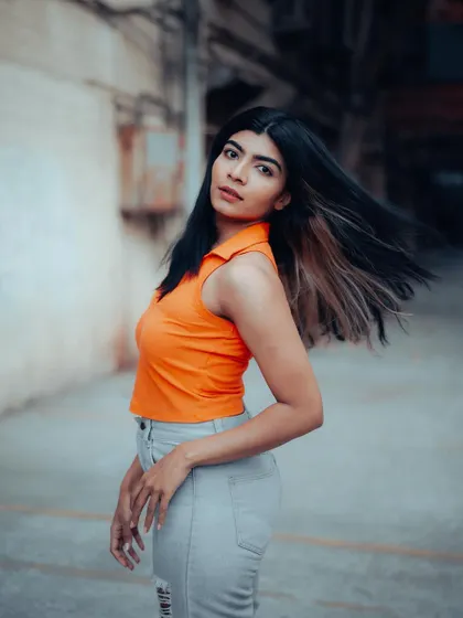 A dynamic shot of a model with her hair in motion, captured in an urban alley. This adds a sense of energy and life to the portrait series.