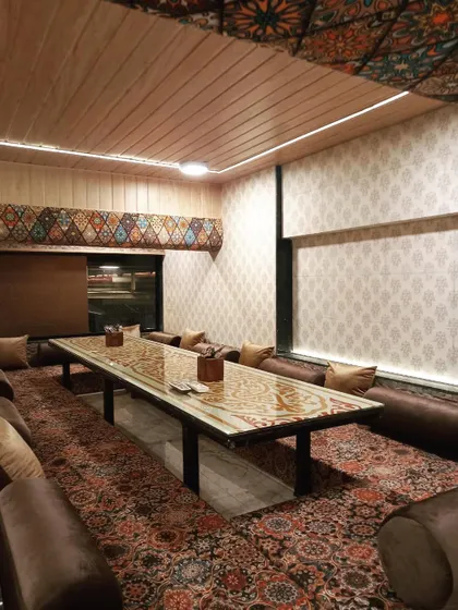 The cozy and intimate ambiance of one of my private Dastarkhwan sections. This setup is ideal for families or groups looking for their own space to enjoy a meal together.