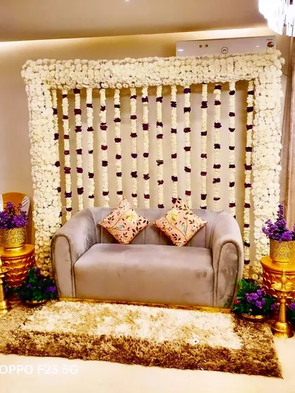 A classy and traditional floral decoration for Annie's Godh Bharai ceremony. We used strings of white and red flowers to create a beautiful backdrop for the celebration.