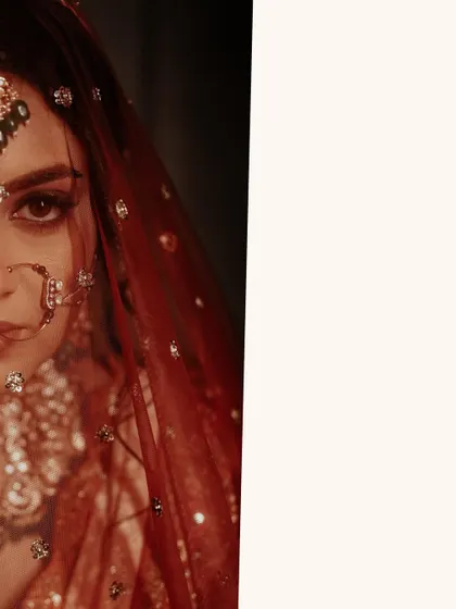 An extreme close-up that is both artistic and intense. The frame focuses on the bride's eye, nose ring, and the sparkling details of her veil, creating a powerful and intimate portrait.