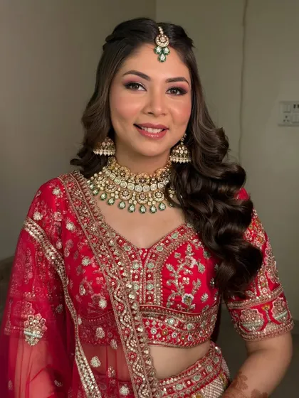 A classic red bridal dream. This look features a lit-from-within base, warm-toned sculpting, and rich red smoked eyes with a soft shimmer to make the bride shine.