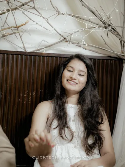 A close-up of the bride's joyful expression as she holds her partner's hand, capturing a moment of pure happiness.