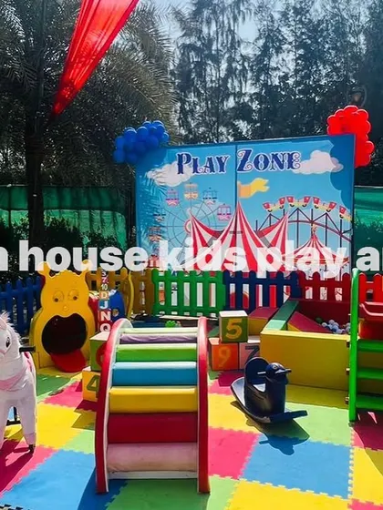 The rainbow play area ready for a fun-filled day at an outdoor carnival party.