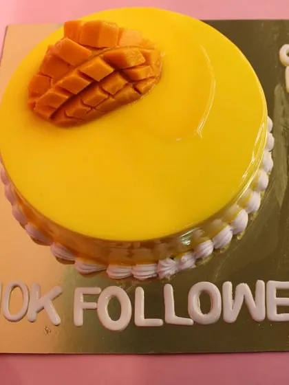 Another view of the 10k followers celebration Mango Cake, topped with a carved mango rose.