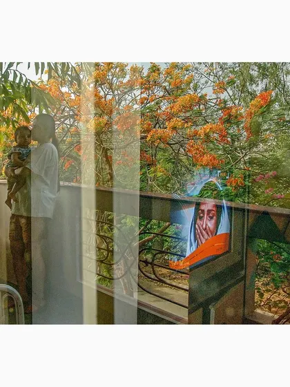 A tender moment between a parent and child is reflected and layered with blooming trees and another portrait. This image from my 'Reflections' series weaves together themes of family, nature, and art.