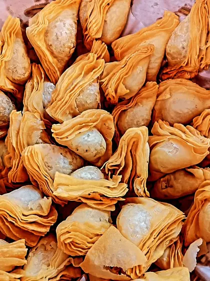 Another view of our crispy, multi-layered warkhi samosas, a signature item that is always a crowd-pleaser at events.