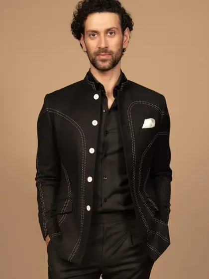A confident pose in the black contrast-stitched Bandhgala. This piece is a fusion of tradition and modernity, perfect for the man who appreciates unique details.