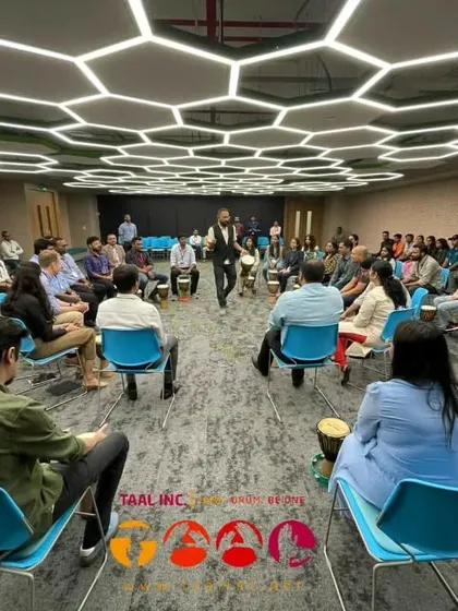 A wide shot showing the scale of a corporate drum circle. Even in a large group, the facilitator ensures everyone feels seen and included, creating a powerful sense of unity.