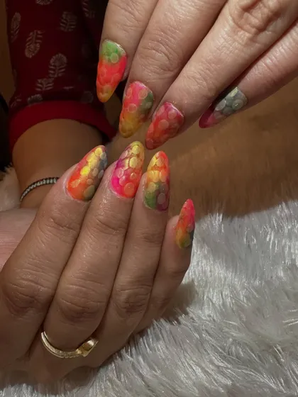 Celebrating Holi with a splash of color. These nails feature a vibrant, multi-colored base with a textured, snakeskin-like effect, perfectly capturing the joyful and playful spirit of the festival.