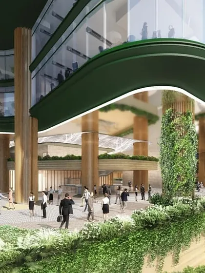 The ground-level view of the NESCO project, illustrating how the building's entrance is designed to be a bustling public space. The use of natural materials like wood and extensive vertical gardens blurs the line between indoors and outdoors.