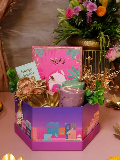 Our Luxe Hamper is the ultimate gift of love and light for Diwali. This hexagonal box is filled with festive delights and beautiful keepsakes, including our sweets box, scented candles, and more.