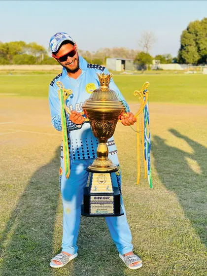 A player celebrating with the Rizvi Cup. The joy of victory is the ultimate reward for the countless hours of hard work on the training ground.