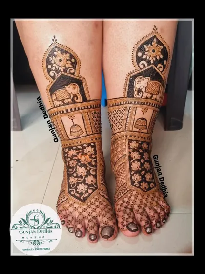 A beautiful bridal leg design featuring elephants, bells, and floral cutwork. The combination of different elements creates a rich and unique pattern.