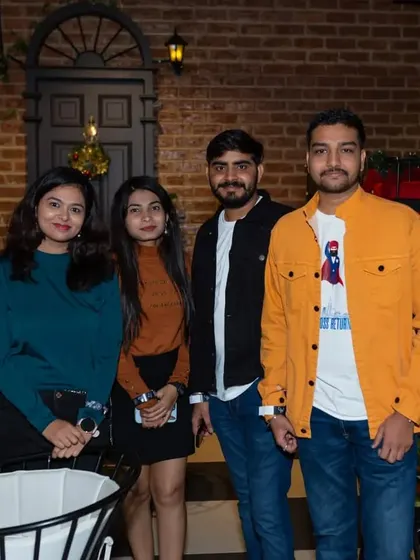 A group of friends posing near the entrance, ready to start their night of fun.
