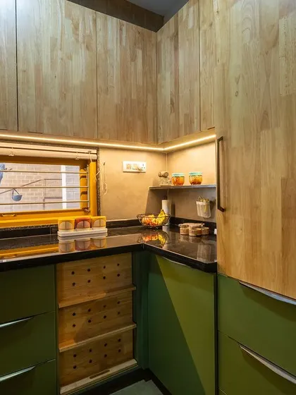 Under-cabinet lighting highlights the workspace, while the wooden upper cabinets add warmth to the design.