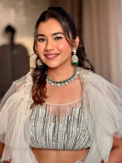 A bright, happy smile to complete the look. The glowing skin and subtle shimmer on the eyes make this a perfect example of modern party makeup.
