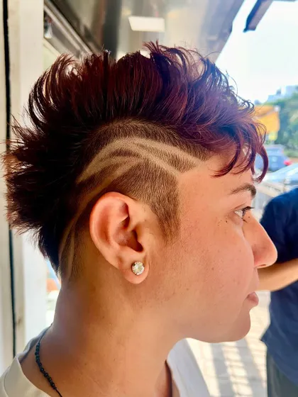 A side view of a creative hair tattoo. The clean lines and sharp design add a unique and artistic edge to this haircut.
