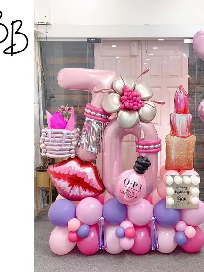 Kisses and wishes for a beauty enthusiast! This makeup-themed arrangement for a 16th birthday is packed with details, including a sculpted lipstick, nail polish bottle, and a shopping bag.