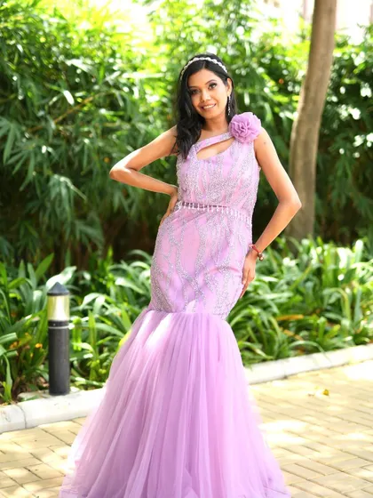 A full-length shot of the beautiful lavender gown. The makeup is elegant and sophisticated, completing this picture-perfect look.