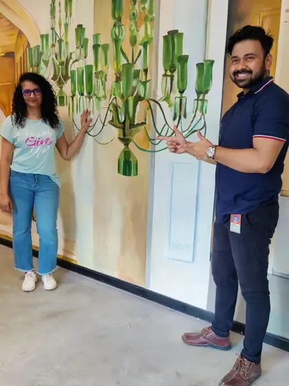 Posing with a happy client from the Microsoft team in front of the nearly completed chandelier mural.