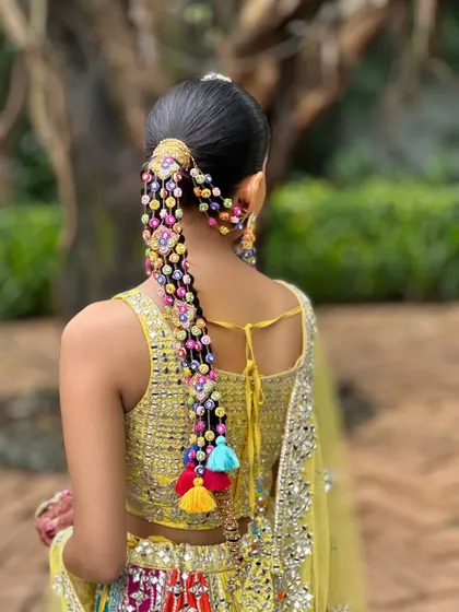 Another angle of this stunning Haldi braid. The accessories are perfectly integrated into the hairstyle, creating a cohesive and eye-catching statement piece.