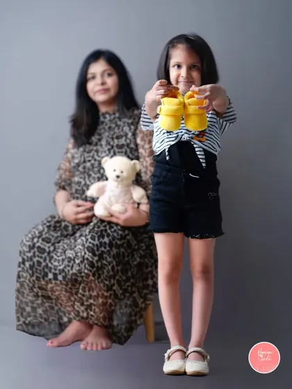 A big sister eagerly awaiting her new best friend. This maternity shoot beautifully includes the older sibling, capturing her excitement for the new arrival.