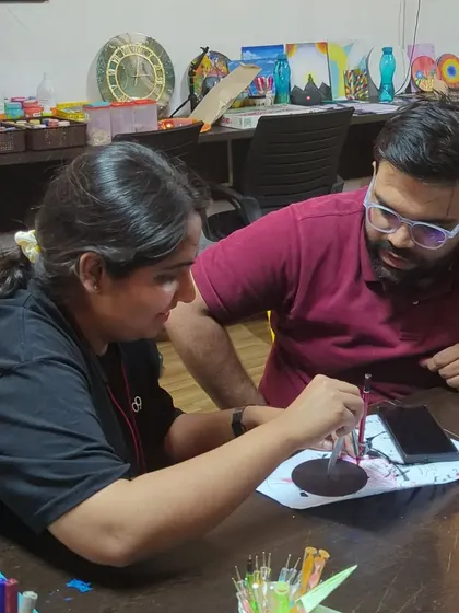 Our founder, Nisha, helping a participant with a dot mandala during our DIY event.