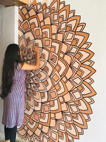 I love working with earthy, monochrome palettes. This half mandala mural uses shades of brown to create a warm and inviting corner piece that feels both modern and traditional.