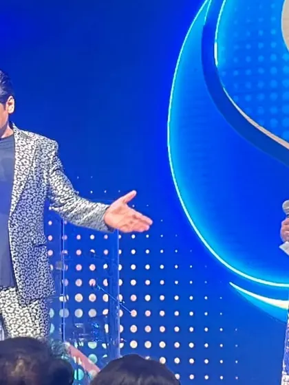 Sharing a laugh with singer Shaan on stage. Building a rapport with the main performer is key to a successful concert, creating a dynamic and entertaining experience for the audience.