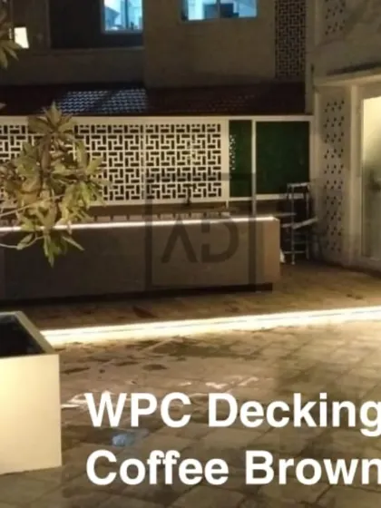 This angle shows the full scope of the terrace, with the WPC decking providing a consistent, clean floor surface that connects the different zones, from the seating area to the decorative screen wall.