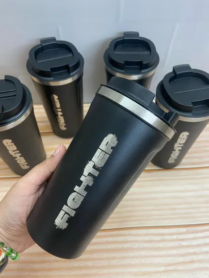 A closer look at the 'Fighter' branded coffee flask, a practical and stylish piece of merchandise.