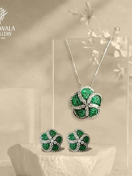 A beautiful matching set of a floral emerald pendant and earrings. This showcases how I design collections that allow for a complete, coordinated, and elegant look.