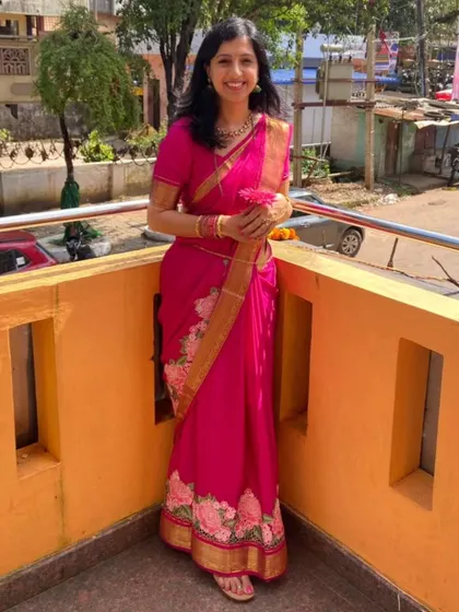 Our client looks radiant in her pink pure Mysore crepe saree with floral embroidery.