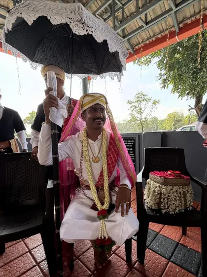 A proud moment at my brother's wedding, where he is seen in the traditional Kodava groom's attire, complete with the ceremonial dagger and headwear.